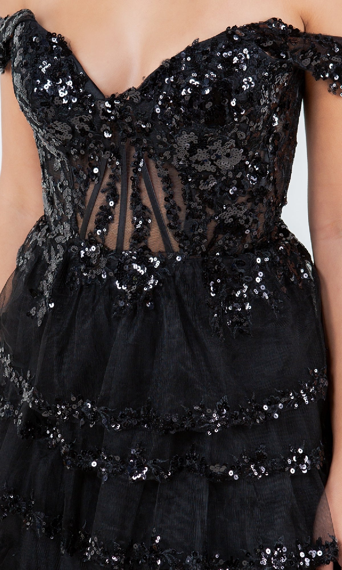 Close-up of the Cinderella Couture 8228J Ruffle Prom Ball Gown, a black off-the-shoulder dress with sheer panels, sequin embroidery, delicate lace accents, and a tiered skirt.